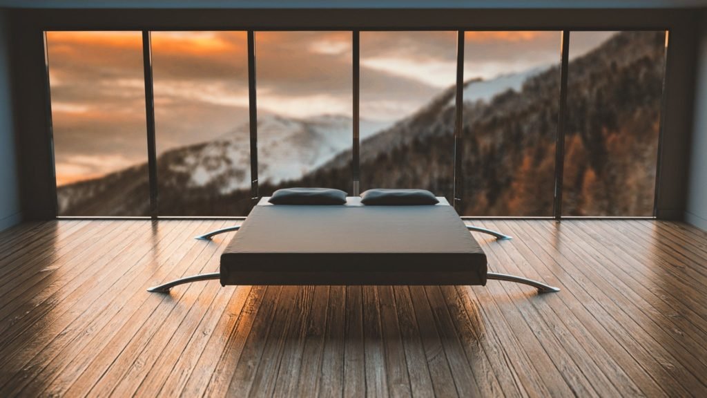 Ein Latexmatratze-Bett in einem Zimmer mit Blick auf die Berge.